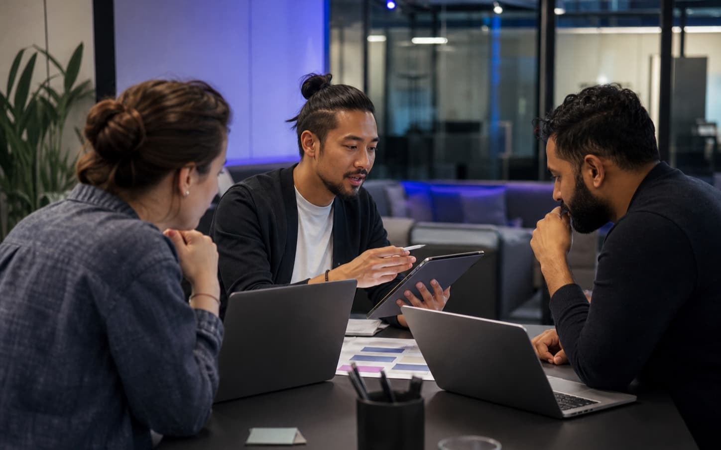 Illustrative scene of three people collaborating in a modern workspace