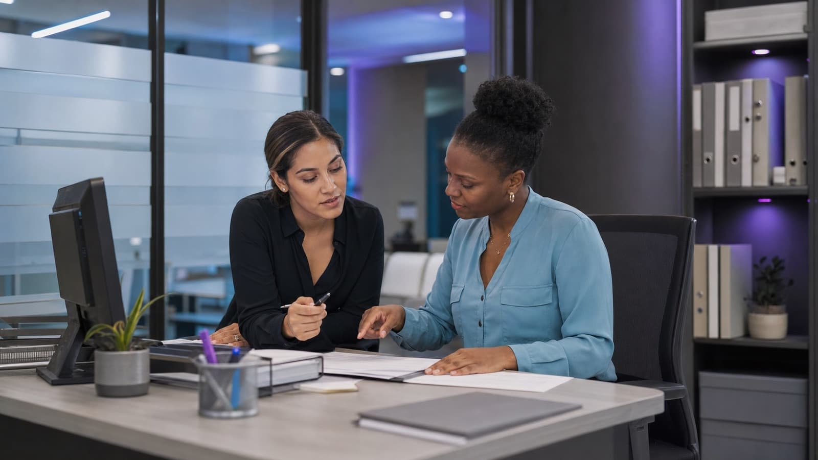 Illustrative healthcare administration scene of two staff members reviewing operational paperwork